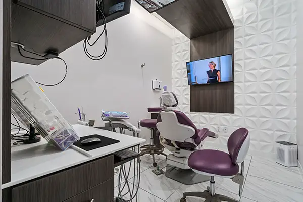 Exam room at Capitol Square Dental, chair and TV