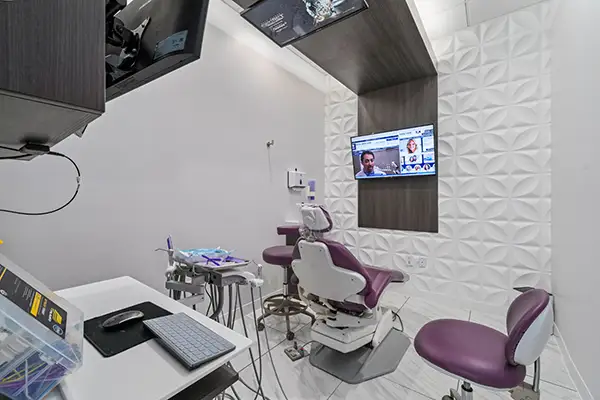 Exam room at Capitol Square Dental, chair and TV