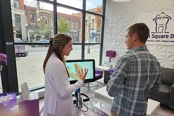 A doctor talking to a patient at Capitol Square Dental