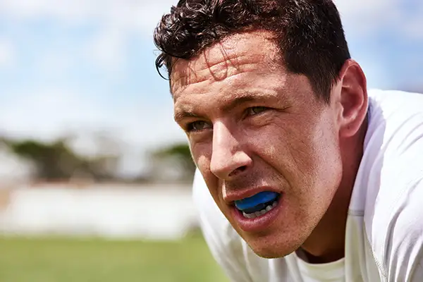 Athletic man ready to play a game with a sports guard from Capitol Square Dental 