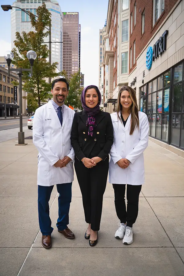 Dr. Mehrdad Safavian with partner and staff member in front of Capitol Square Dental