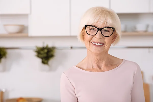 Image of older woman woman avoiding diary after receiving dental implant from Capitol Square Dental 