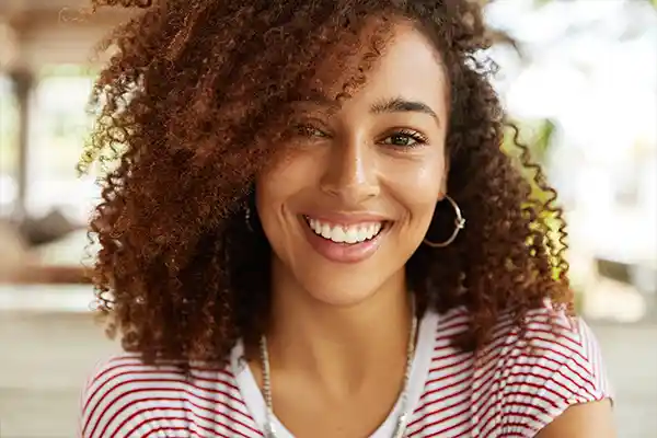 Image of woman with straight teeth after treatment at Capitol Square Dental 