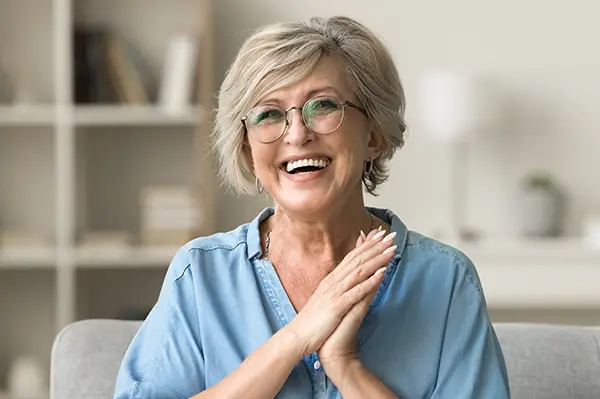 Image Woman smiling with dentures from Capitol Square Dental 