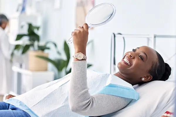 Woman smiling after her teeth are restored