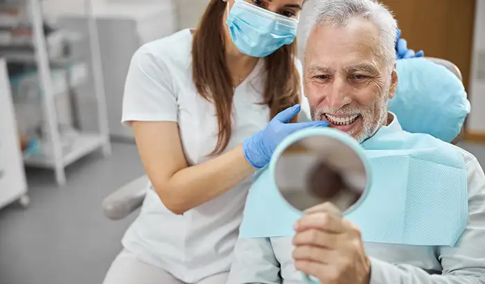 Image of a man with dentures at Capitol Square Dental 